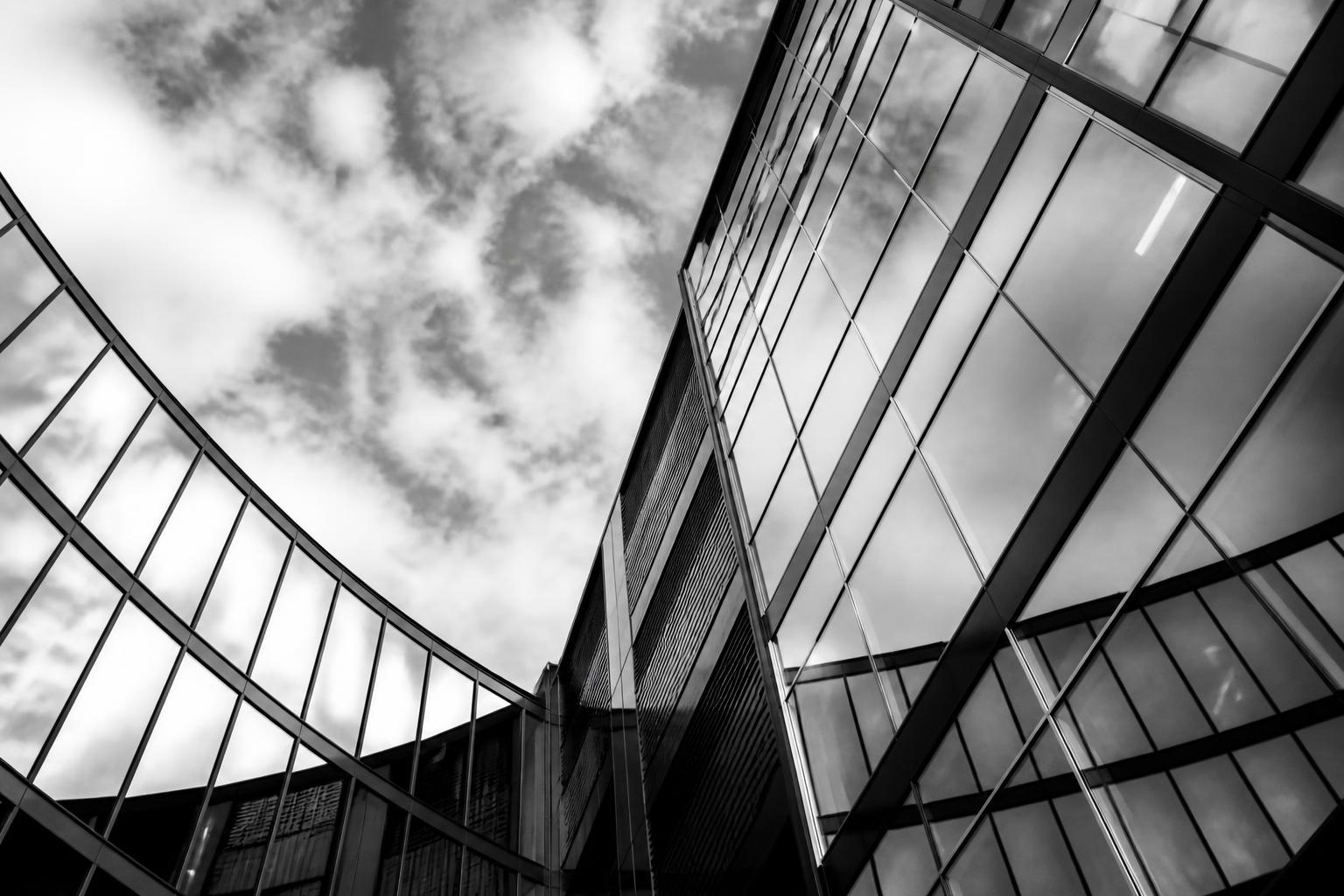 Modern glass building facade reaching upward